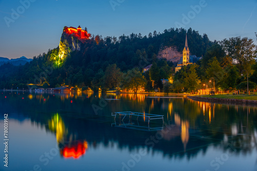 Sunset view of Saint Martin church and Bled castle in Slovenia © dudlajzov