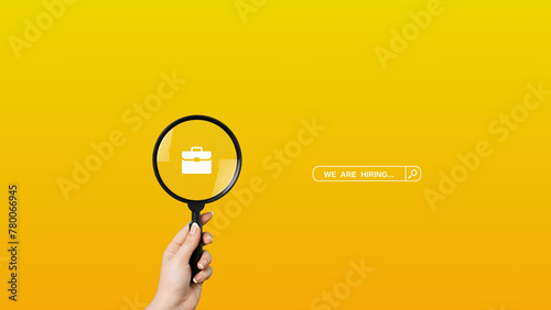 We are Hiring a design with a Magnifying Glass on a yellow background. Minimal we are hiring background. 