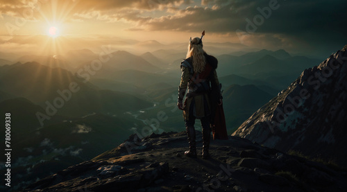 Viking in armor stands in the rocky mountains