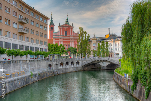 Franciscan Church of the Annunciation ant the riverside of Ljubl photo