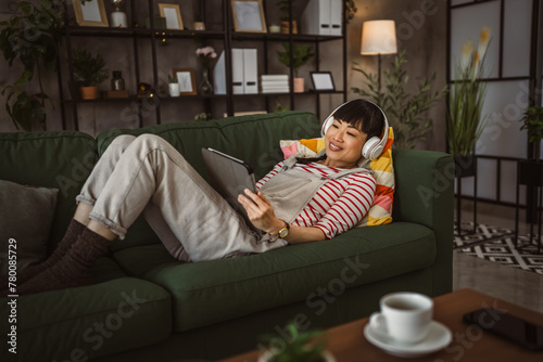 Woman sit at home use digital tablet to watch movie or have video call