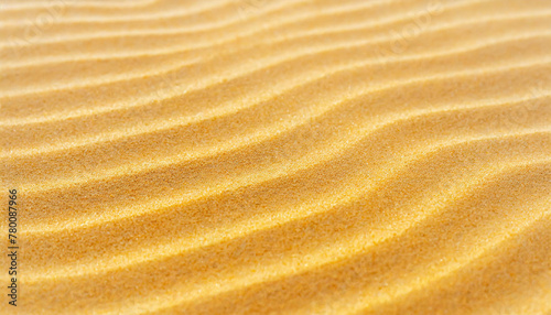 Golden desert sand dunes with a wave pattern, perfect for nature backgrounds.