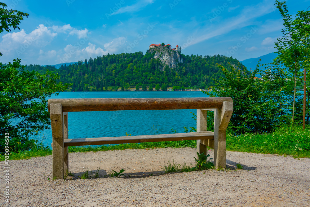 Obraz premium a bench looking at Bled castle in Slovenia