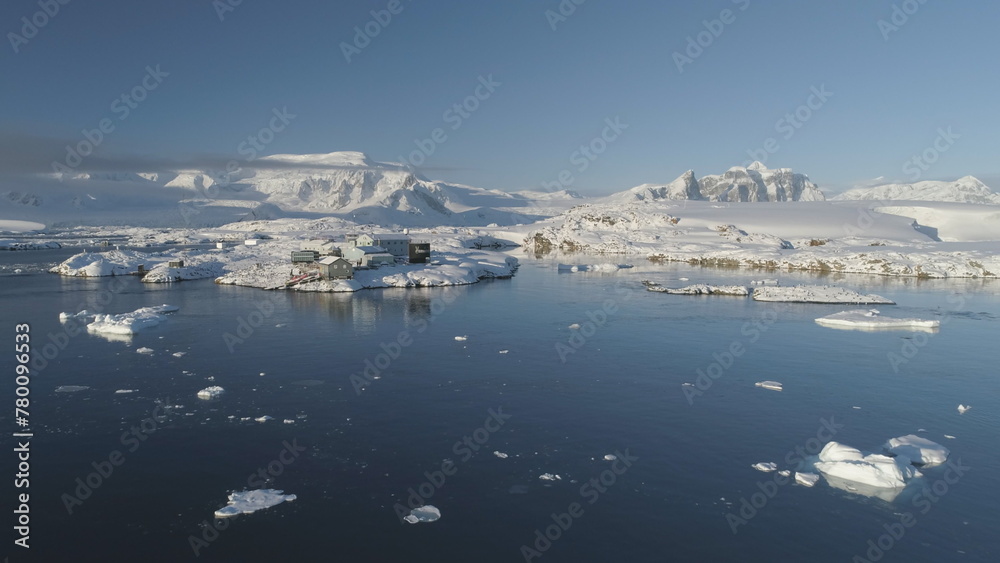 Drone View of Antarctic Science Station - Vernadsky Base. Ocean Coast Open Water Surface. South Pole Settlement Base Majestic Landscape Aerial Slow Speed Flight Drone View of Antarctic Science Station - Vernadsky Base. Ocean Coast Open Water Surface. South Pole Settlement Base Majestic Landscape Aerial Slow Speed Flight