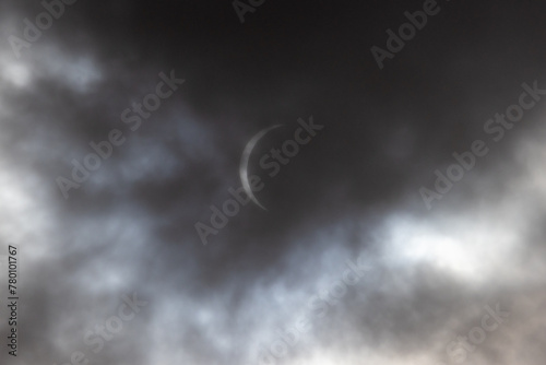 Solar Eclipse is seen through dramatic gray cloudy skies in Sussex County, New Jersey 