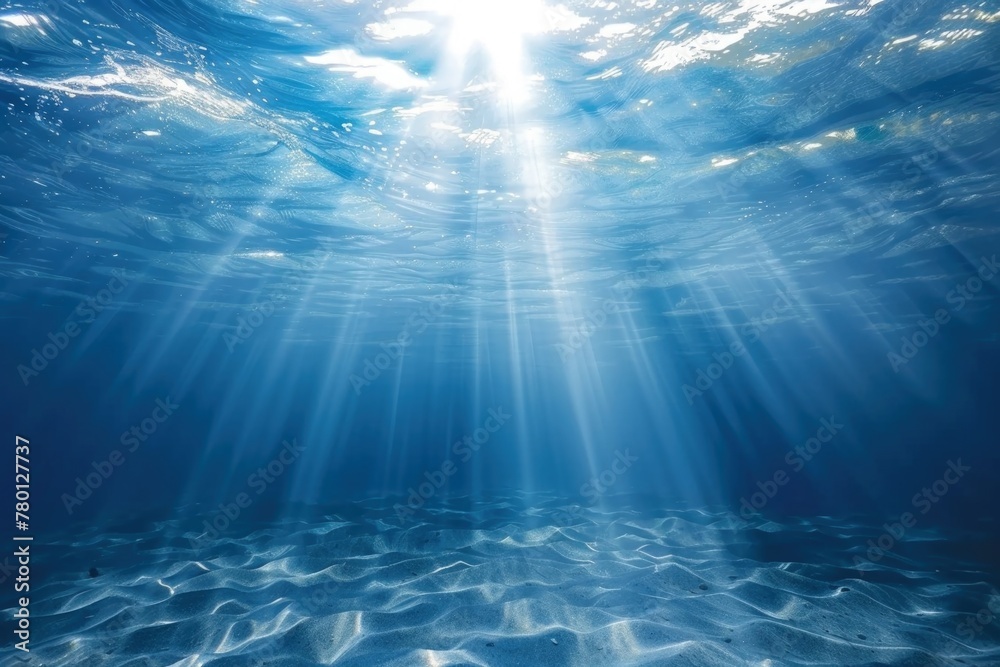 Bottom of the sea with sun reflection shining through the water.