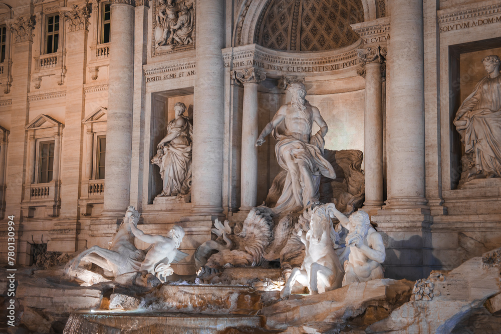 Trevi Fountain, Rome, Italy illuminated Baroque masterpiece with intricate sculptures, towering statue of Oceanus, cascading water, and Corinthian columns.