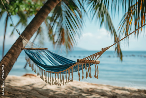 Hammock between palm trees on an idyllic tropical beach, beautiful ocean view. Exotic travel mood, summer vacation background concept. © SARATSTOCK