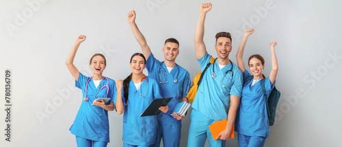 Group of happy medical students on light background photo