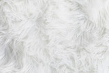 Full frame of soft fake white fur rug. Overhead top view plush pattern fabric.