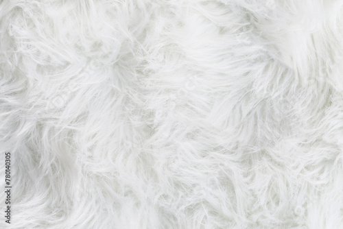 Full frame of soft fake white fur rug. Overhead top view plush pattern fabric.