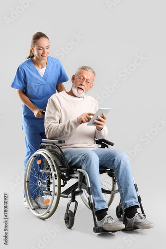 Senior man in wheelchair us...