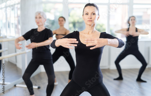 Graceful women of different ages practice various ballet movements in a choreographic studio
