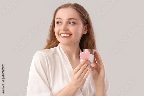 Smiling woman in white robe...