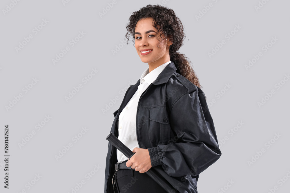 African-American female police officer with baton on white background African-American female police officer with baton on white background