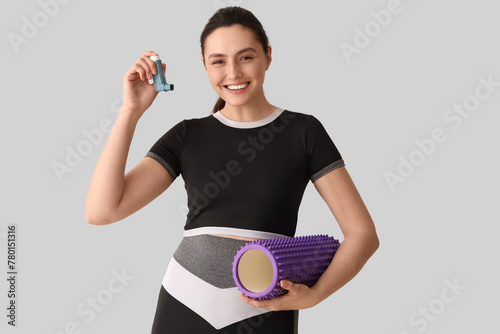 Smiling woman holding asthm...