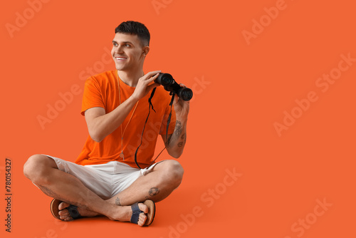 Male lifeguard with binocul...