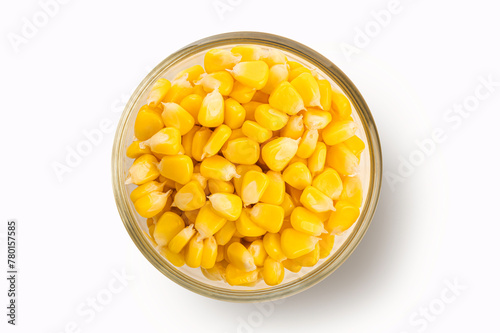 Corn seeds in a glass bowl on white background. Top view