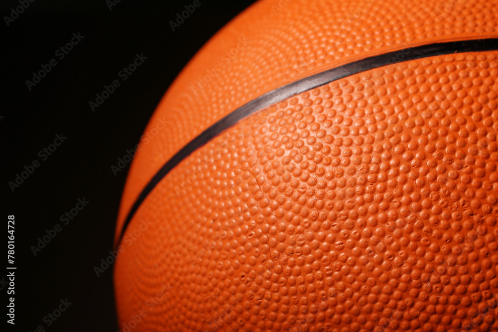 Fototapeta premium Ball for playing basketball game on black background, closeup