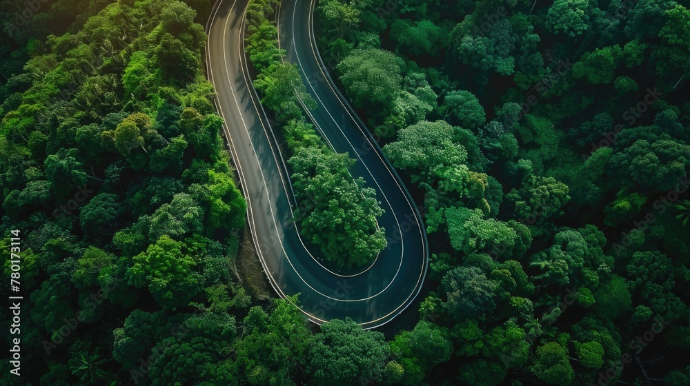 Aerial top view beautiful curve road on green forest in the rain season. Aerial top view beautiful curve road on green forest in the rain season.