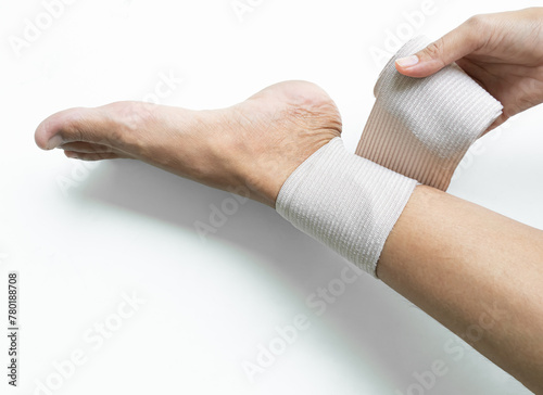 Woman Gauze Bandage  Wrapping Leg Food she Ankle Sprain Broken Injured Surgery Accident Pain Hurt, Concept fro Health Medical Hospital. photo