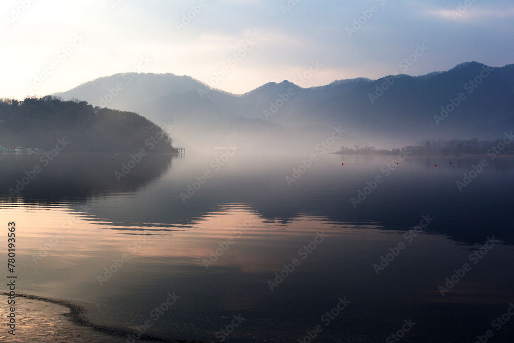 Fototapeta premium View of the foggy lake in the morning