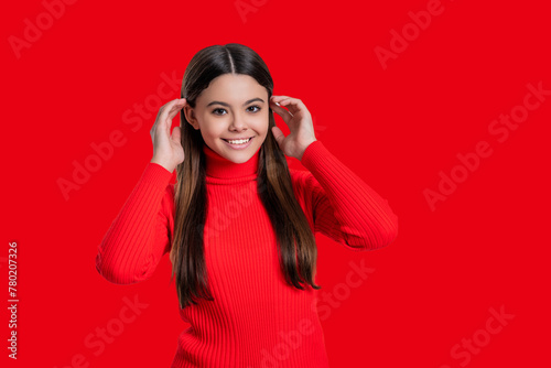 Casual style. Stylish girl has long hair. Teen monochrome fashion style. Style for girl. Headshot portrait of happy teen girl isolated on red. Teen girl looking at camera. Copy space