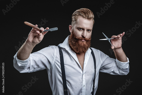 Haircut at hairdresser man. Barber making hairstyle. Advertising for barbershop. Hairdressing skills of man. Retro hairdresser holding razor and scissors isolated on black. Hairstylist serving