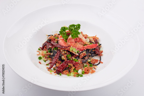 Black pasta stir fried chilli with shrimp topped with parsley, dried chilli, sliced spring onion, fried garlic, and cheese. Black spaghetti made from the ink in the squid.