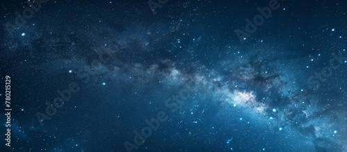 Captivating close-up view of a vast galaxy filled with countless shimmering stars against a serene blue sky backdrop