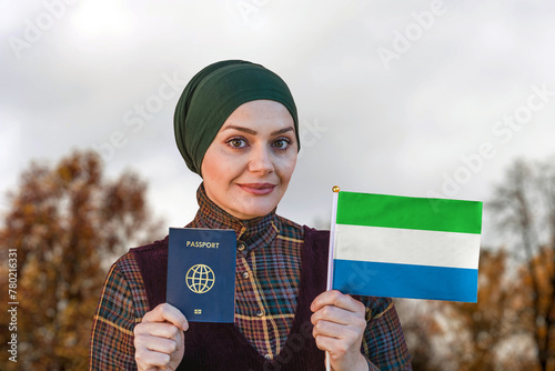 Muslim Woman Holding Passport and Flag of Sierra Leone
