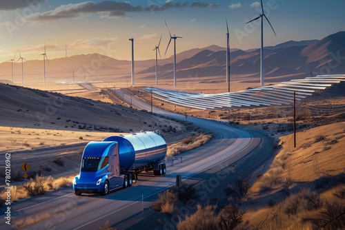 Cutting-edge electric truck hauling a colossal blue hydrogen gas tank down a highway, with sweeping rows of wind turbines and solar panels stretching out toward the horizon. photo