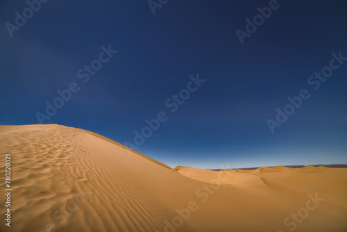 A panoramic sand dune of sahara desert at Mhamid el Ghizlane in Morocco wide shot