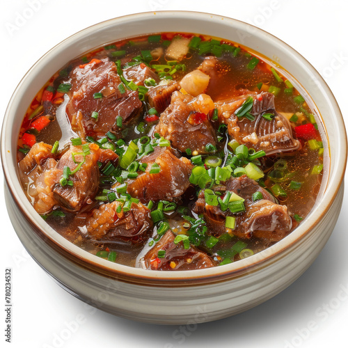 Hearty beef soup with fresh herbs and vibrant vegetables in a white bowl.