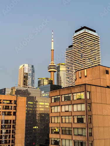 view through street canyons of Toronto downtown of famous CN Tower a landmark of the Canadian city 