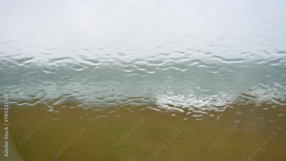 Rain runoff on the car windshield in rainy weather Rain runoff on the car windshield in rainy weather