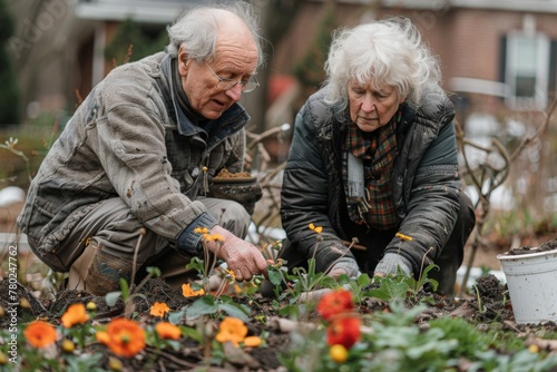 Elderly couple engaged in gardening, planting colorful flowers together.