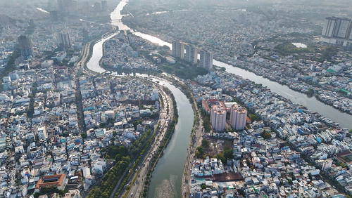 Ho chi Minh city aerial view with canal system, overcrowded riverside urban, Vo Van Kiet avenue along Tau Hu canal, dense density and crowded townhouse of big Asian town, Saigon, Viet Nam
