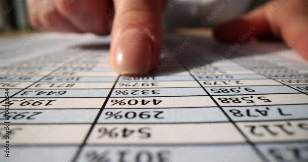 Accountant works with many numbers in table on piece of paper