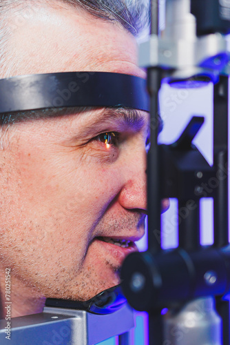 Checking a man's vision with a modern microscope at an appointment with an ophthalmologist. Vision treatment.