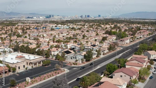 Aerial pullback shot of Henderson Nevada suburb with city skyline and roads