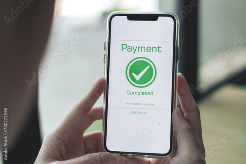 Payment complete Notifications. Customer using online banking application on smartphone to pay for purchases online and product in department store