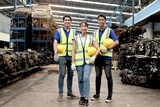 Three of industrial workers wear safety vest, hold helmet, stand together at manufacturing plant industry factory. Professional engineer team full skill at workplace. Workers ready to start operation.