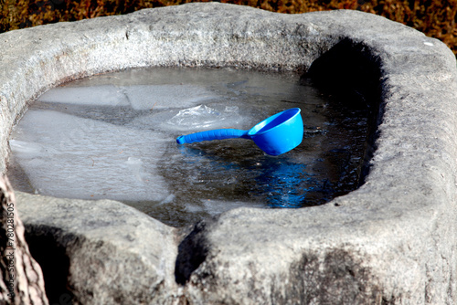 blue bucket on the frozen water photo