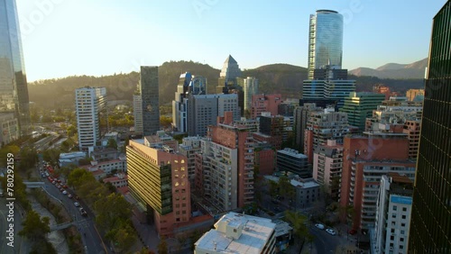 Aerial establishing shot of Santiago downtown skyline at sunset, El Gold neighborhood, Chile photo