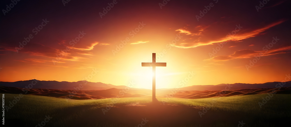 A cross stands atop a hill as the sun sets in the background, casting a warm glow over the landscape. Friday concept. 
