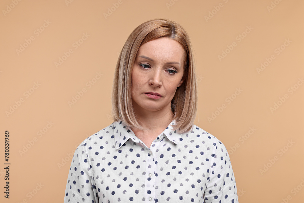 Portrait of sad woman on beige background Portrait of sad woman on beige background