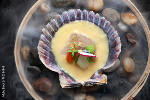 Overhead view of clam shell with upscale seafood bite photo