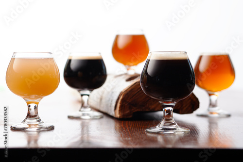 Five round glasses of different beers on a table photo