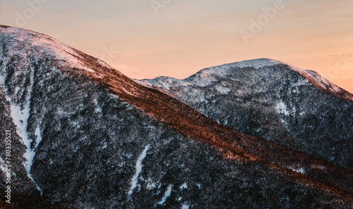 Evening light hits a snow covered mountain ridge, New Hampshire photo